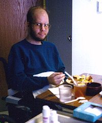 Andy practising feeding himself with his right hand, late Dec. 1996